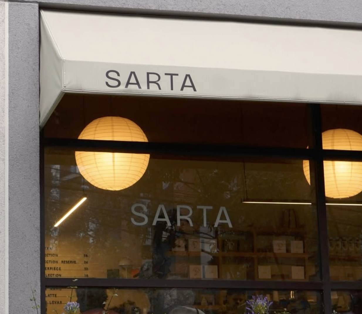 The minimalist corner storefront at Sarta Coffee